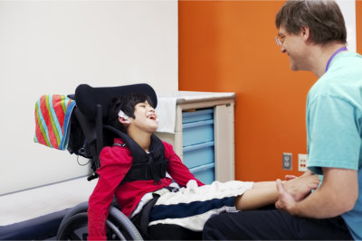 Staff assisting the child with disability